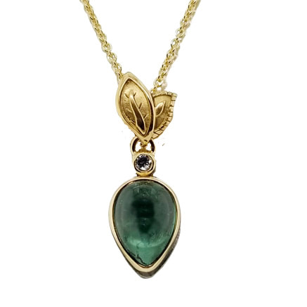 18 Karat Yellow Gold pendant with a pair shaped Green Tourmaline and Leaves.