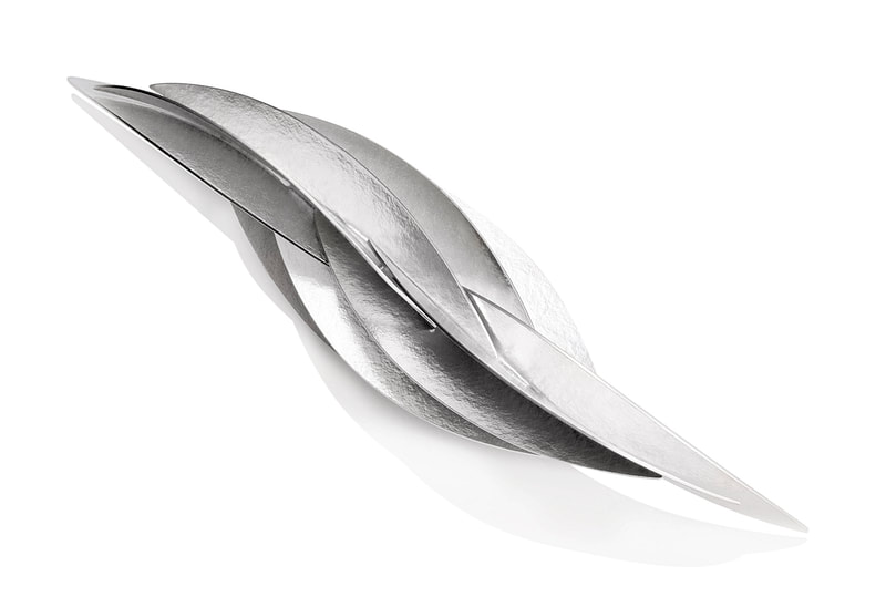 Sterling Silver pin with layers of curved silver pieces in a marquise shape.