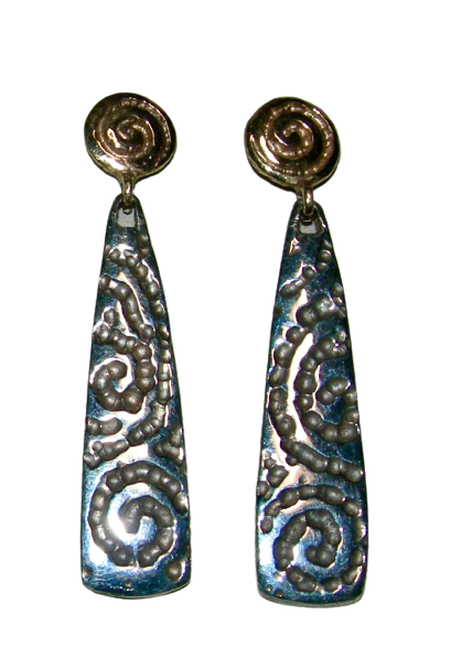 Carved dangle earrings with gold round tops and an elongated silver patterned dangle.