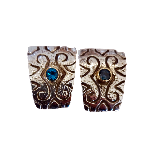 Sterling Silver carved earrings with yellow gold bezeled round Blue Topaz stones in the center of each.