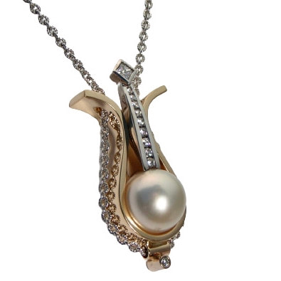 Yellow and White 14 Karat Gold Pendant with Diamonds and one White Pearl on a chain.