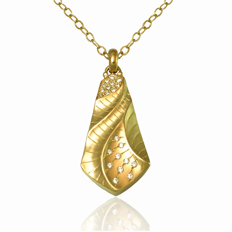 18 Karat Yellow Gold kite-shaped pendant with scattered diamonds on a link chain.