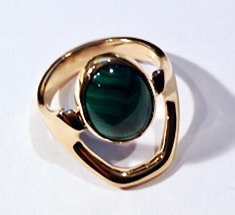 14 Karat Yellow Gold angular ring with an oval shaped Malachite in the center.