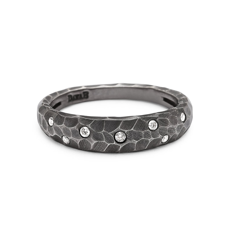 Oxidized hammered band ring with flush set diamonds.