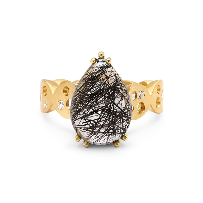 18 Karat Yellow Gold ring with a pear shaped tourmalated quartz in the center.