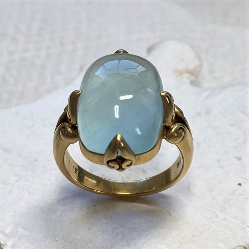18 Karat Yellow Gold ring with an Aquamarine in the center.