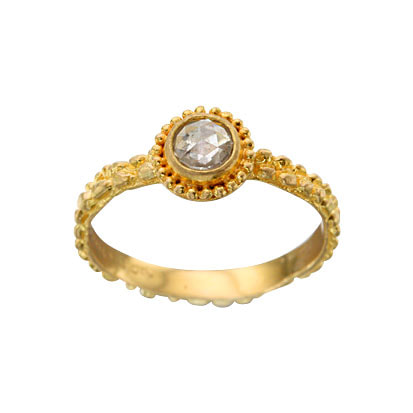 18 Karat Yellow Gold ring with a textured band, a diamond in the center surrounded with milgrain.