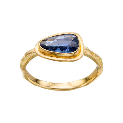 18 Karat Yellow Gold ring with  a Blue Sapphire in the center.