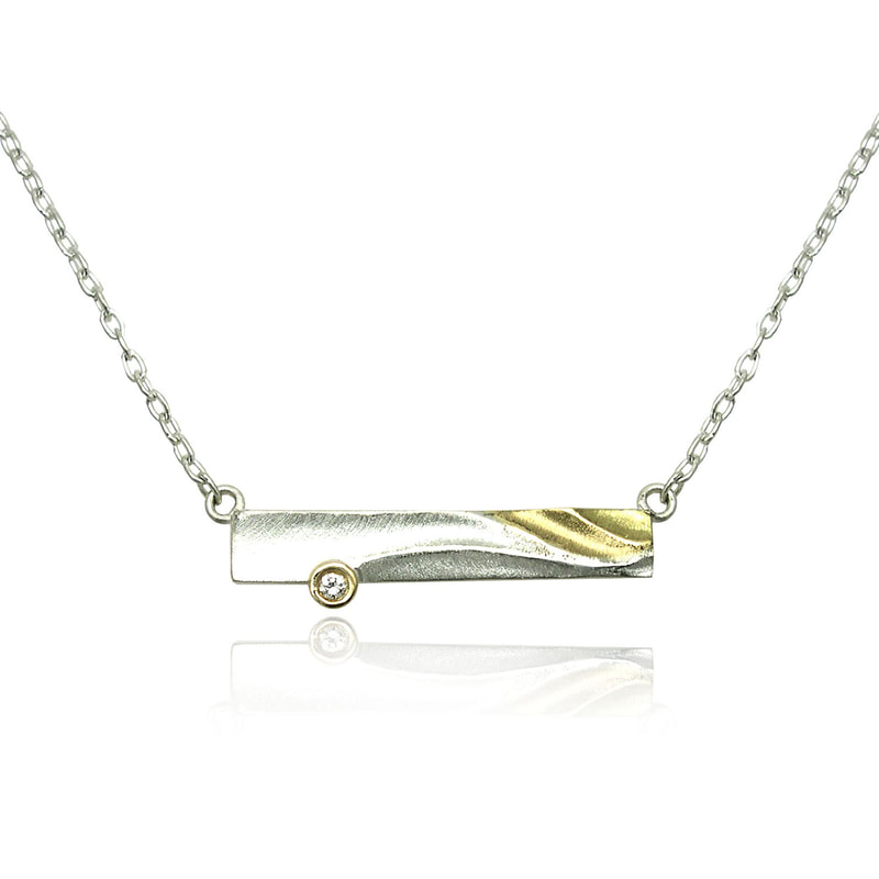 18 Karat Yellow Gold and Silver rectangular pendant with a diamond attached to a Silver chain on each side.