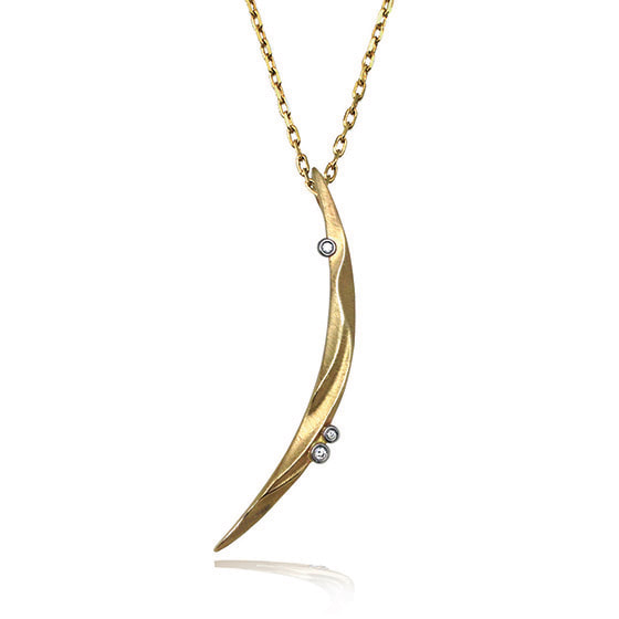14 Karat Yellow gold crescent shaped sculpted pendant with three diamonds.