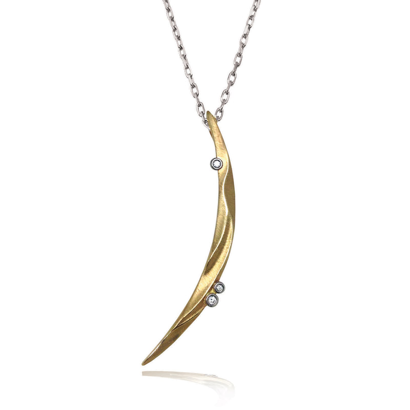 14 Karat Yellow Gold crescent shaped pendant with small diamonds on a silver chain.