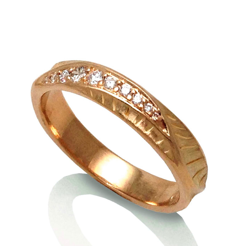 18 Karat Rose Gold 4mm Ring with inset diamonds on the top and a textured band.
