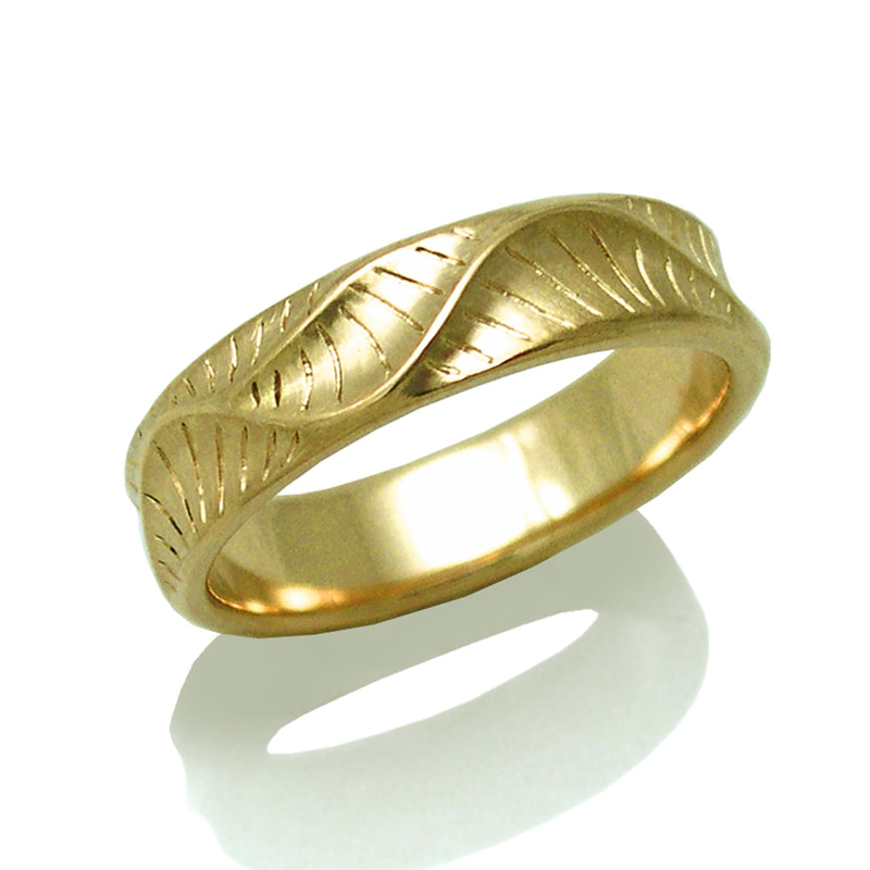 18 Karat Yellow Gold 6mm band with waves and texture.