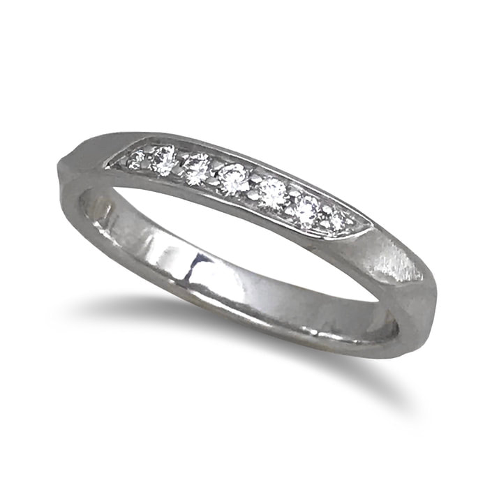 14 Karat White Gold band ring with diamonds along the top.