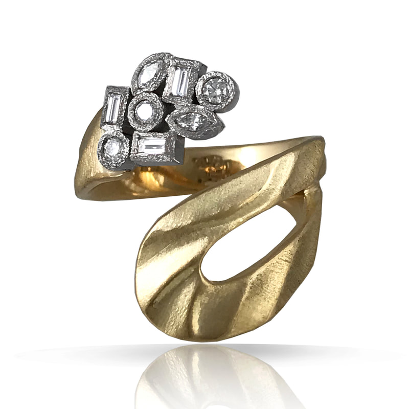 18 Karat Yellow Gold bypass ring with multi-shaped bezel set diamonds.
