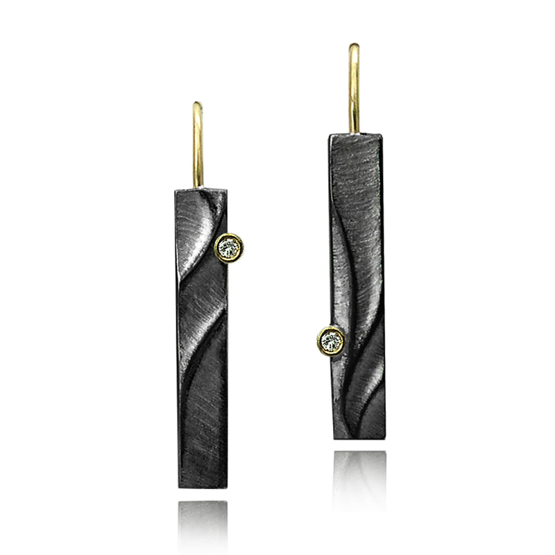 Blackened elongated rectangular earrings with gold wires and diamond accents.