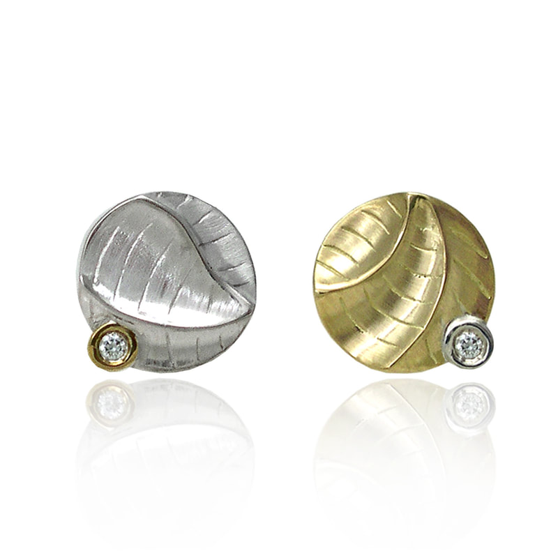 Gold and silver stud earrings with sculpted designs and diamond accents, opposite colors.