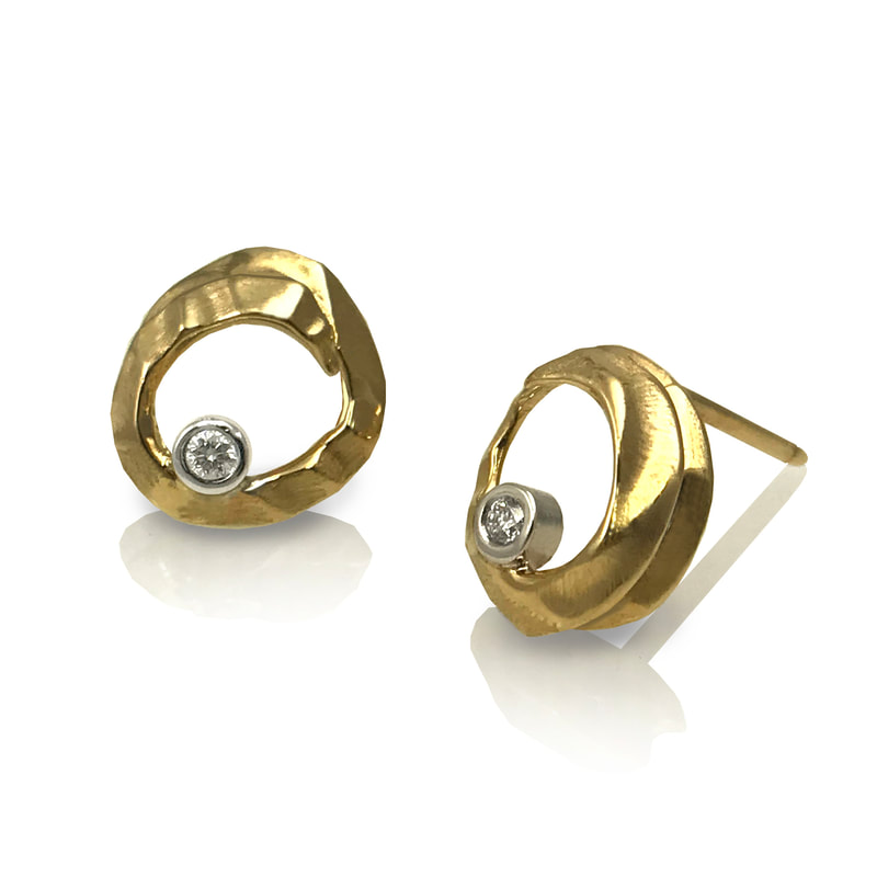 Yellow Gold open earrings with a small diamond.