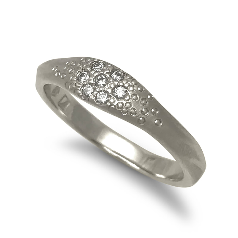 14 Karat White Gold ring with a cluster of diamonds on the top.