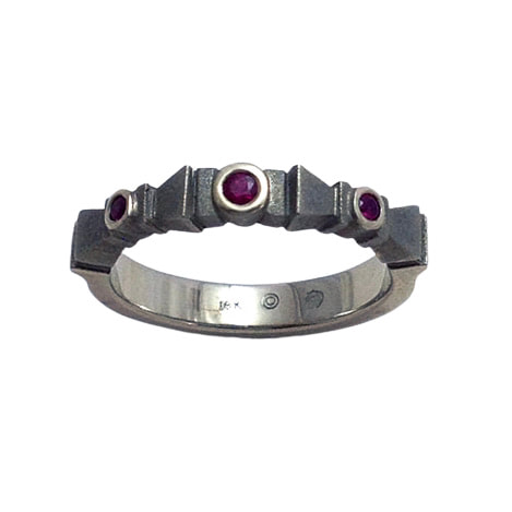 18 Karat White Gold ring with three Rubies on an angled band.