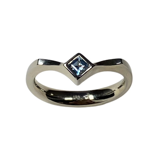 18 Karat White Gold ring with a a Princess Cut Aquamarine on an angled band.