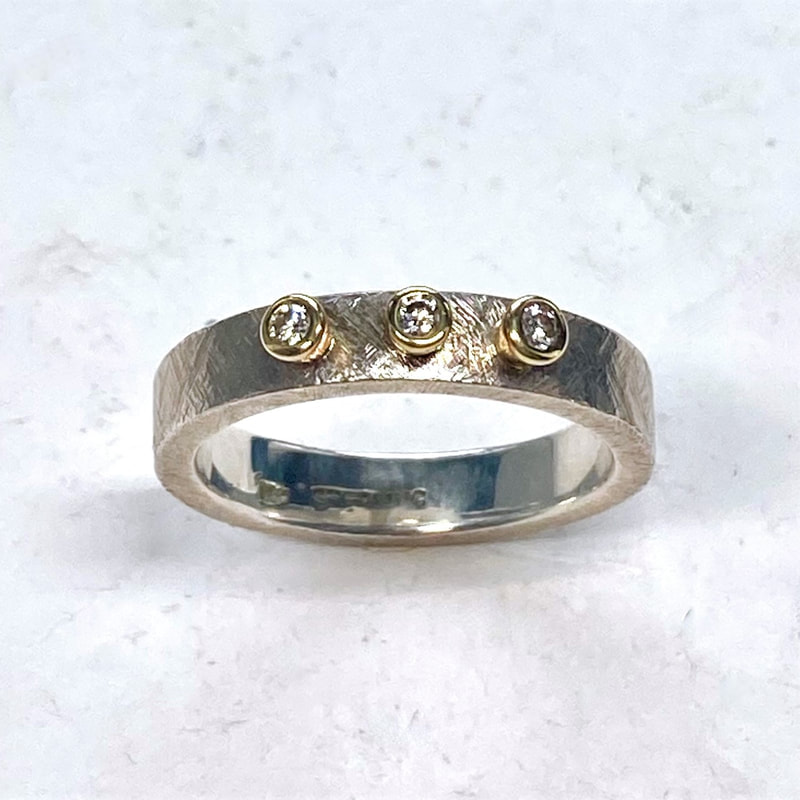 18K Yellow Gold & Sterling Silver flat 4mm band ring with three bezel-set round diamonds.