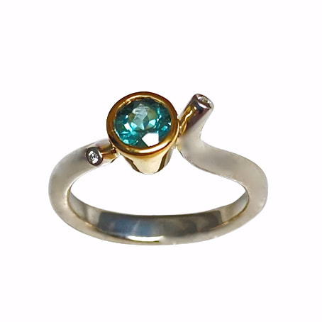 Sterling Silver and 18 Karat Yellow Gold ring with a bezel set Round Green Tourmaline & Diamonds..