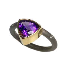 18 Karat Yellow and White Gold ring with darkened band with flush set diamonds and one off-set Trillion shaped Amethyst.