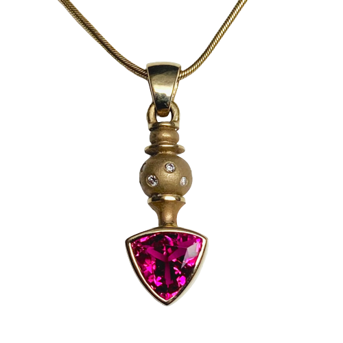 18 Karat Yellow Gold Pendant with a Trillion Pink Tourmaline and scattered diamonds.