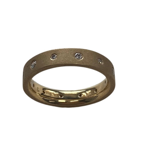 18 Karat Yellow Gold ring with a matte finished ring with flush-set diamonds all the way around.