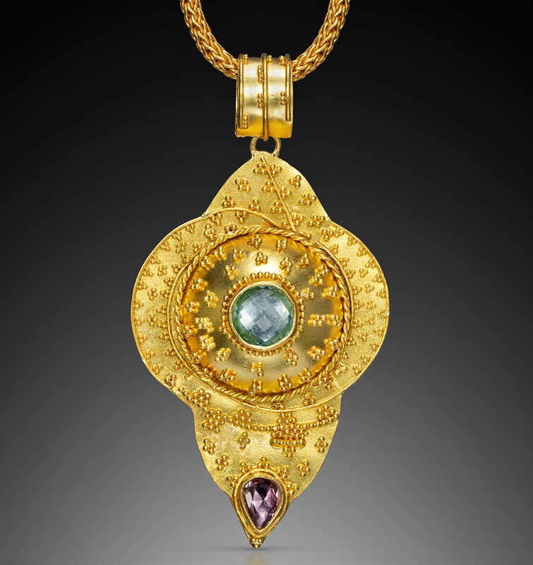 18 Karat Yellow Gold pendant with a Blue and a Purple Topaz and 22 Karat Yellow Gold Granulation throughout.