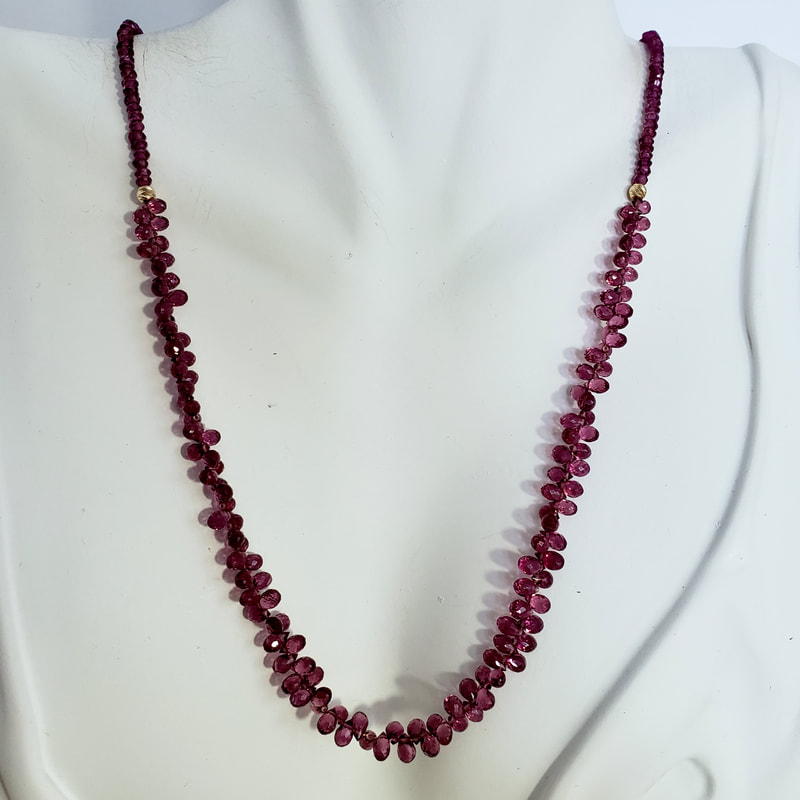 14 Karat Yellow Gold Rhodolite Garnet necklace with roundish beads leading into pear shaped faceted Garnets in the center.