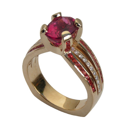 14 Karat Yellow Gold Ring with Rubelite in the Center, Orange Sapphires and diamonds.