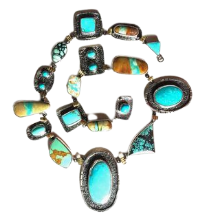 Sterling Silver Necklace with 22KY between stations of all different shapes and kinds of Turquoise.