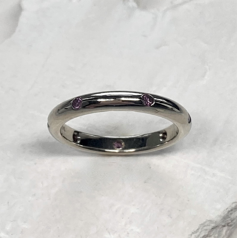 14 Karat White Gold High Dome ring with 0.19Ctw Irradiated Purple Diamonds.