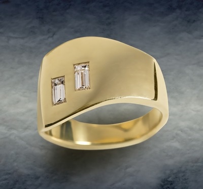 18 Karat Yellow Gold slant band with squared top and baguette diamonds.