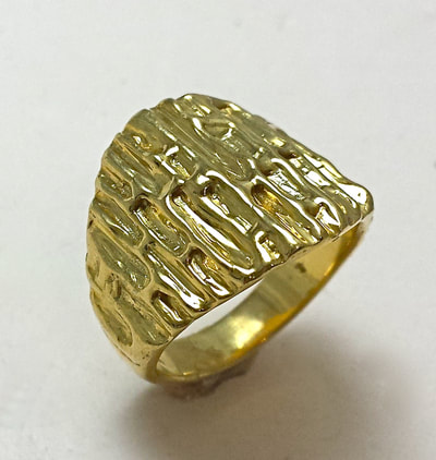 18 Karat Yellow Gold wide tapering ring with bark like texture.