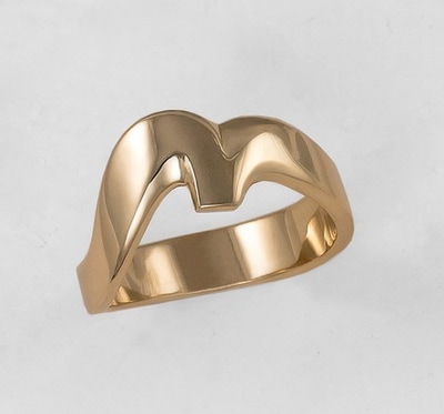 Yellow gold curved band, looks like a bird in flight.