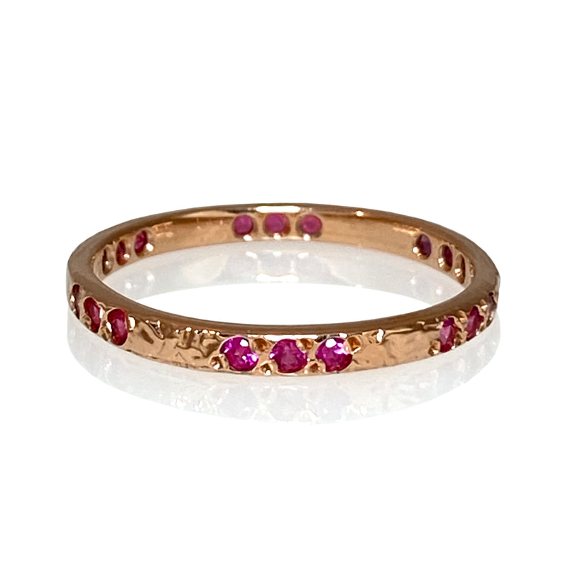14 Karat Rose Gold 2mm band with Pink Sapphires all the way around.