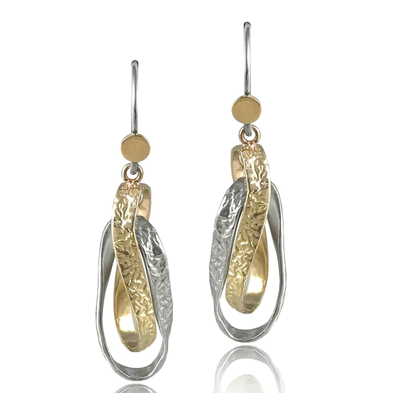 14 Karat Yellow Gold and Silver entwined ribbon-like loop dangle earrings.