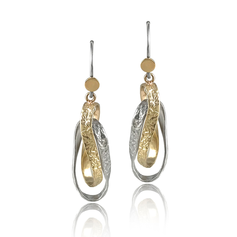 14 Karat Yellow Gold and Sterling Silver intertwined ribbon like elongated earrings.
