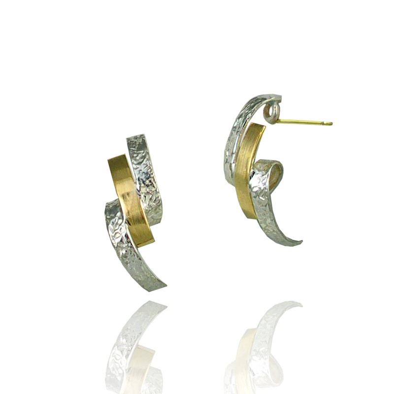 18 Karat Yellow Gold and Sterling Silver ribbon like twisted post earrings.